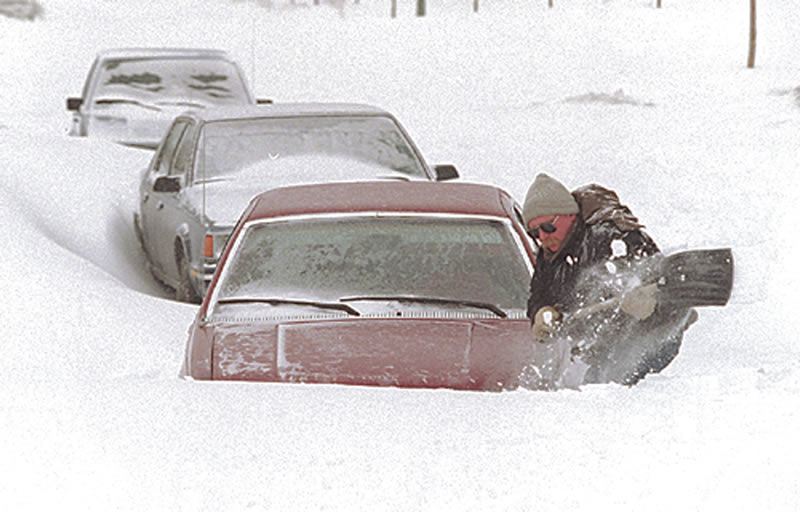 A man shovels out his car during the Winnipeg snowstorm of 1997